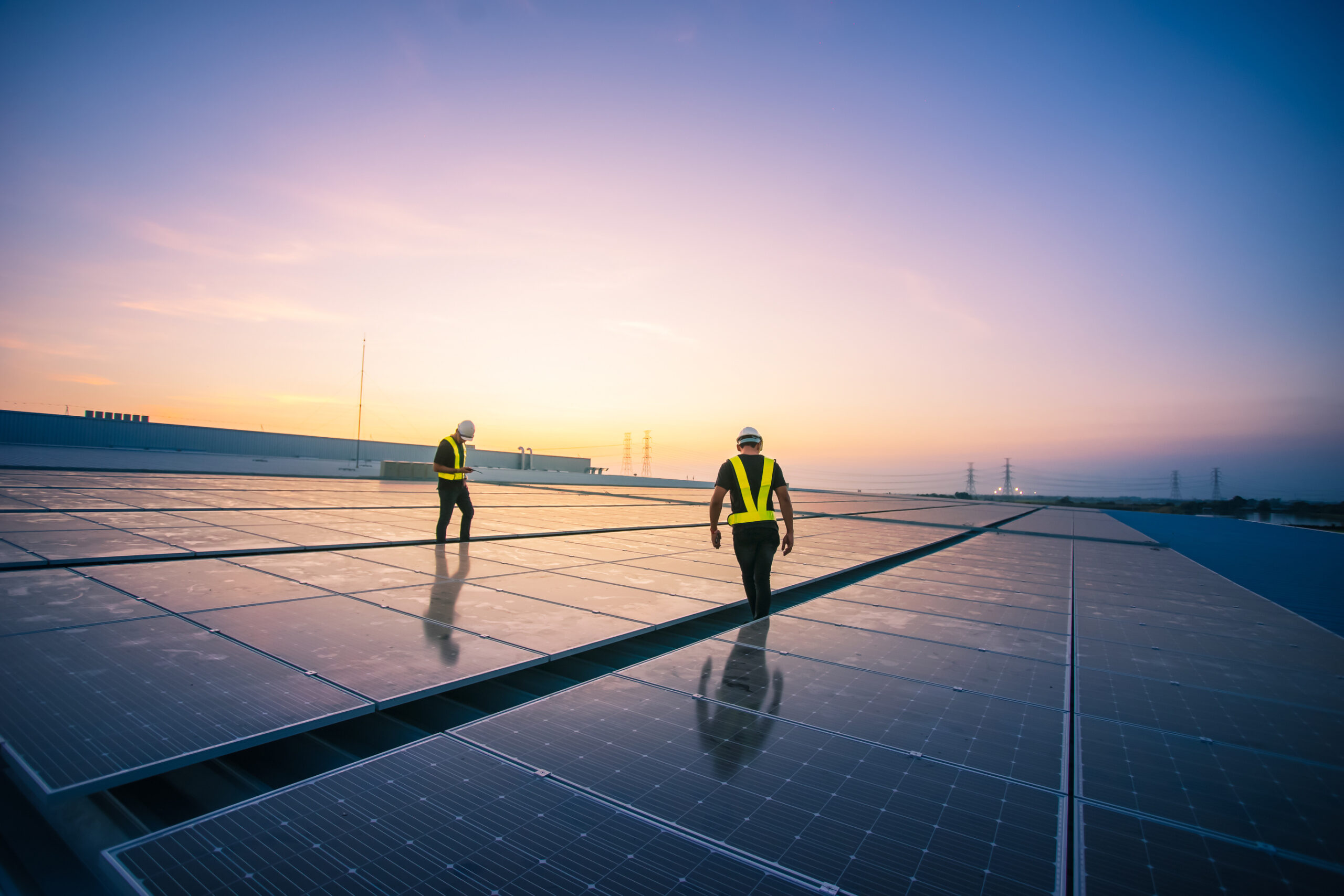 Technology solar cell, Engineer service check installation solar cell on the roof of factory on the morning. Silhouette technician inspection and repair solar cell on the roof of factory.